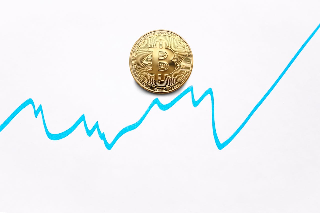 hero-img-01 Gold bitcoin cryptocurrency coin and blue graph of changes of value on white background